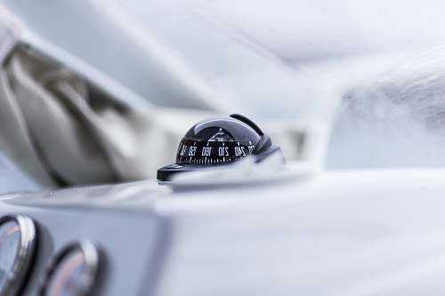 boat instrument closeup photography of vehicle compass direction